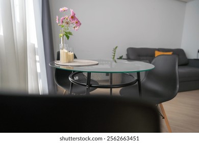 Apartment Glass Table Flowers: Modern living room interior design, showcasing stylish furniture and floral arrangement.