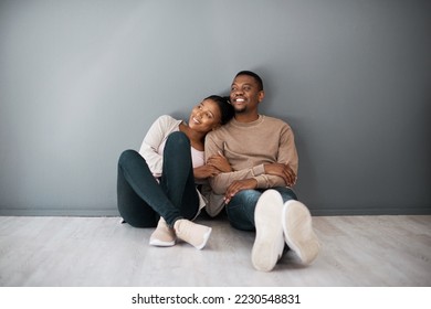 Apartment, love and couple on floor with wall background relax, rest and bond after moving in new home together. Real estate, dating and young black couple in living room thinking of house design - Shutterstock ID 2230548831