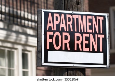 Apartment For Rent Sign In Front Of An Apartment Building