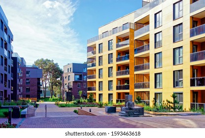 Apartment In Residential Building Exterior. Housing Structure At Blue Modern House Of Europe. Rental Home In City District On Summer. Wall And Glass High Architecture For Business Property Investment.