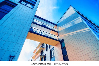 Apartment In Residential Building Exterior. Housing Structure At Blue Modern House Of Europe. Rental Home In City District On Summer. Wall And Glass High Architecture For Business Property Investment.
