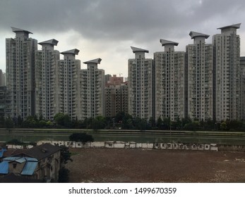 Apartments In Urban Chinese Setting With Derelict Land In Foreground