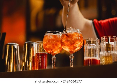 Aperol spritz being prepared on the bar in a cocktail bar. - Powered by Shutterstock