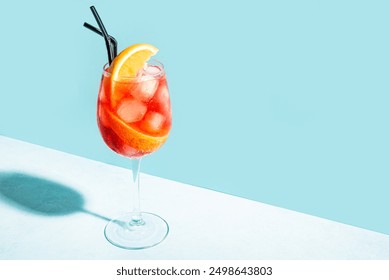 Aperol Spritz Cocktail in glass with orange slices on blue background, copy space.  Alcohol Aperol Spritz Aperetivo. - Powered by Shutterstock