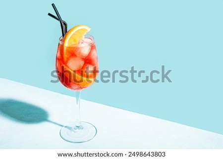 Aperol Spritz Cocktail in glass with orange slices on blue background, copy space.  Alcohol Aperol Spritz Aperetivo.