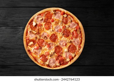 Apetite pizza on a black wooden background top view with sausage and meat - Powered by Shutterstock