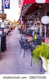 Apex, North Carolina USA-11 20 2021: A Young Man Is Waiting For A Pizza In Downtown Apex.