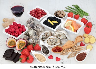 Aphrodisiac love food and drink for valentines day to boost sexual health over distressed white wood background.