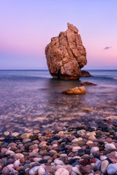 Aphrodite's Rock Or Petra Tou Romiou, The Birthplace Of Goddness Aphrodite, Paphos, Cyprus. Amazing Sunset Seascape With Rock And Sea Pebbles, Vertical Travel Background, Popular Tourist Location