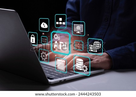API, Application Programming Interface concept. A man using laptop with virtual screen API icon. Software development tool, information technology, modern technology and networking. 