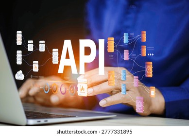API - Application Programming Interface, Man using laptop computer with API icon on office desk, Software development tool, modern technology, internet and networking.