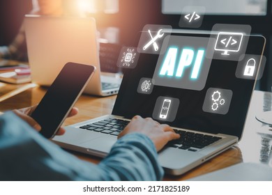 API - Application Programming Interface, Woman using laptop computer with VR screen API icon on office desk, Software development tool, modern technology, internet and networking concept. - Shutterstock ID 2171825189