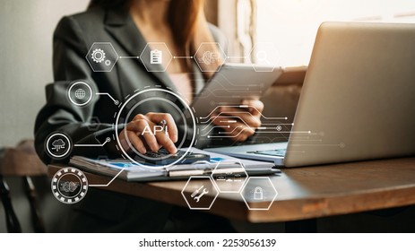 API Application Programming Interface, woman using laptop, tablet with virtual screen API icon Software development tool, modern technology and networking concept. - Shutterstock ID 2253056139