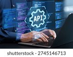 API development. Engineer using laptop computer to design API. Programmer writing code based on the specifications.