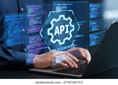 API development. Engineer using laptop computer to design API. Programmer writing code based on the specifications.