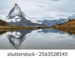 Apls scenery with the Matterhorn Mountain and its reflection in a lake.