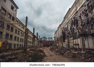 Apocalyptic concept, ruins of abandoned city, old broken factory or warehouse buildings, dark toned