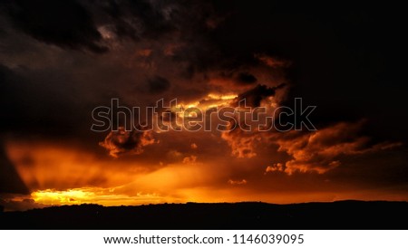 Apocalyptic sunset with fire clouds