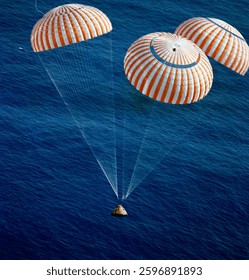 The Apollo 17 Command Module (CM), with astronauts Eugene A. Cernan, Ronald E. Evans and Harrison H. Schmitt aboard, nears splashdown in the South Pacific Ocean. 