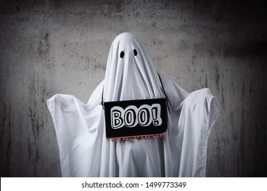 Apologetic Ghost In A Sheet With A Sign That Says 