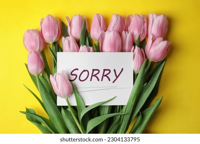 Apology. Card with word Sorry and beautiful pink tulips on yellow background - Shutterstock ID 2304133795