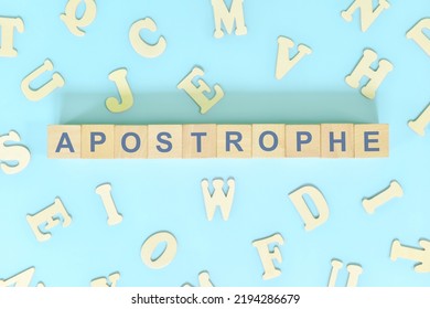 Apostrophe figure of speech concept in English grammar class lesson. Wooden blocks typography flat lay in blue background.