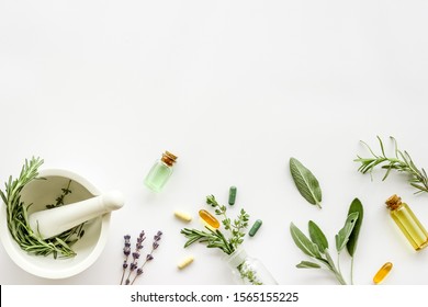Apothecary of natural wellness and self-care. Herbs and medicine on white background top view frame copy space - Shutterstock ID 1565155225