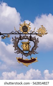 Apothecary Sign In Europe Against Blue Sky And Clouds
