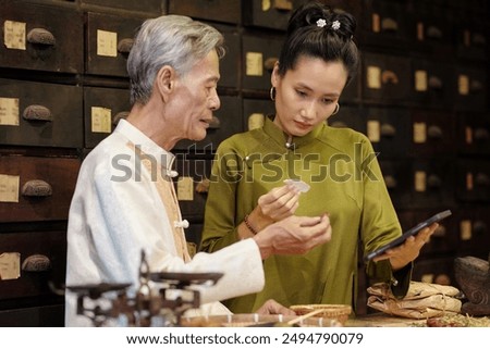 Apothecary Workers Using Gadgets At Work