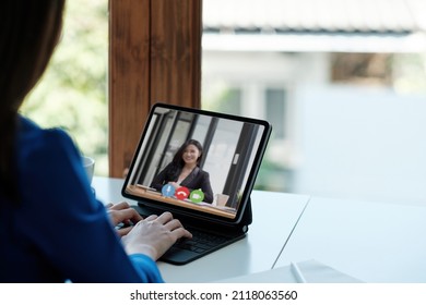 App For Communication With Employees. Online Video Conference. Woman Communicates Via Video Call With Business Partners, He Sits At The Creative Modern Office Space.