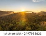 Appalachian mountain hills on autumn evening with brightly illuminated lush and pine woods at fall season. Autumnal landscape of beautiful nature