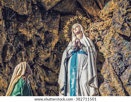 The apparition of the Blessed Virgin Mary surrounded by stars in the grotto of Lourdes