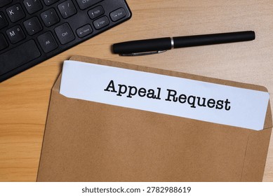 Appeal request document in envelope on office desk, representing formal business review and decision process concept.