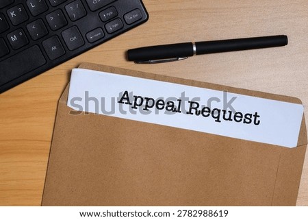 Appeal request document in envelope on office desk, representing formal business review and decision process concept.