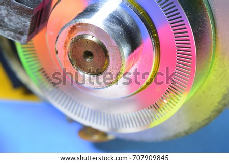 An appearance colorful reflective surface of old DC motor and cylinder encoder. Spare parts for mini CNC Home-made Machines, 3D Printer, ... etc. close up.