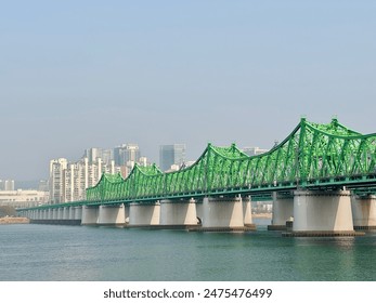 The appearance of the Han River Iron Bridge built with a light green H-beam through which major trains in Seoul, the capital of the Republic of Korea, such as Seoul Subway Line 1. - Powered by Shutterstock