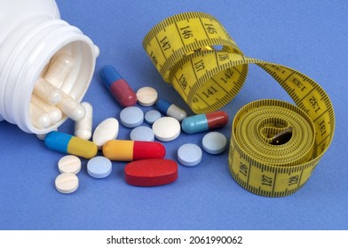 Appetite suppressant and dietary supplement concept with flexible meter and drugs on blue background  - Shutterstock ID 2061990062