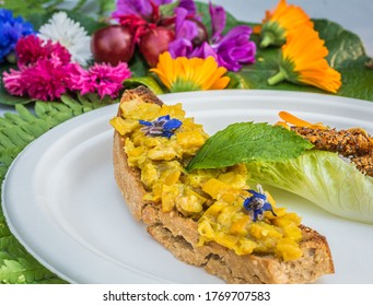 Appetizer Of Calendula Flowers And Crouton. Plate Decorated With Fresh Flowers. Flower Food Concept. Edible Summer Flowers