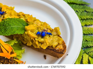 Appetizer Of Calendula Flowers And Crouton. Plate Decorated With Fresh Flowers. Flower Food Concept. Edible Summer Flowers