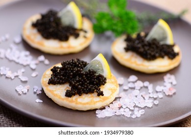 Appetizer, caviar with pancake on plate, closeup.