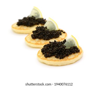Appetizer, caviar with pancake on white background, isolated.