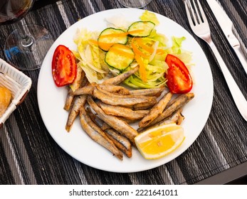 Appetizer Cooked Anchovies (Boquerones) With Vegetable Garnish On White Plate. Spanish Cuisine