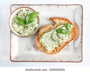 appetizer, delicious Greek or Cretan meze or paste spread on slice of toast bread on table. appetizer originates from Crete island, Greece. greek food made of cheese, garlic and basil, selective focus - Shutterstock ID 2200502201