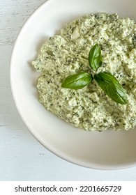 Appetizer, Delicious Greek Or Cretan Meze Or Paste Spread Plate With Basil On Table. Traditional Appetizer From Crete Island, Greece. Greek Food Made Of Cheese, Garlic And Basil, Selective Focus