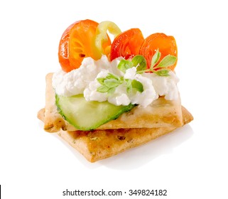 Appetizer On Crackers With Cream Cheese And Vegetables Close-up Isolated On White Background
