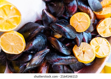 Appetizer Street Food Stuffed Mussels On Bench For Sale With Lemon Which Is Served With A Squirt Of Lemon Juice.