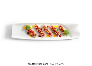 Appetizer With Tuna Tartar, Seasonal Vegetables And Greens On White Restaurant Plate Isolated. Macro Photo Of Delicious Healthy Red Fish Tatar Or Tar-tar Entree Closeup