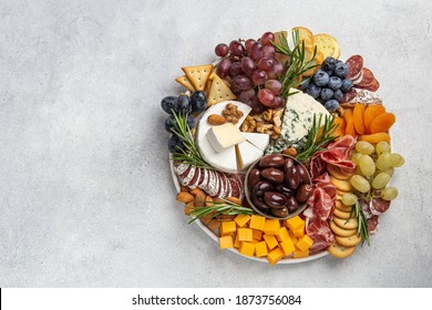 Appetizers Boards With Assorted Cheese, Meat, Grape And Nuts. Charcuterie And Cheese Platter. Top View, Copy Space