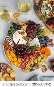 Appetizers boards with assorted cheese, meat, grape and nuts. Charcuterie and cheese platter. Top view - Shutterstock ID 2055883952