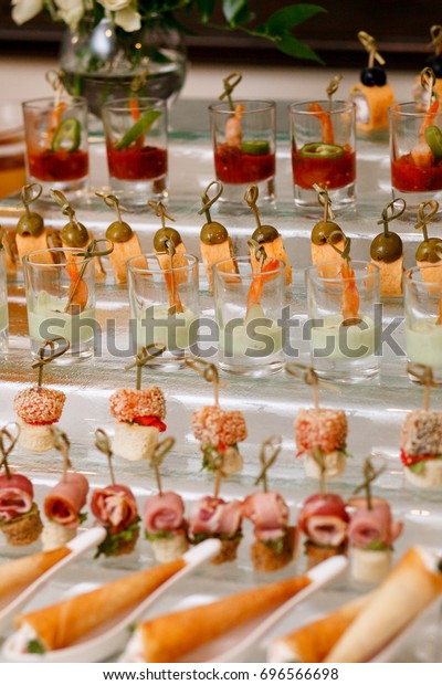 Appetizers,\
gourmet food - canape with cheese and strawberries, blue-berries\
catering service. selective focus, top view.\
